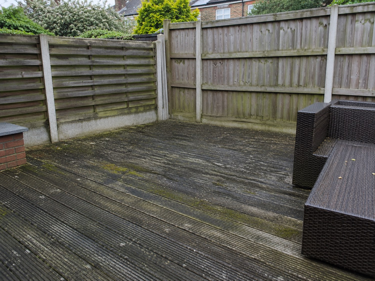 Timber decking before cleaning — grey, weathered boards