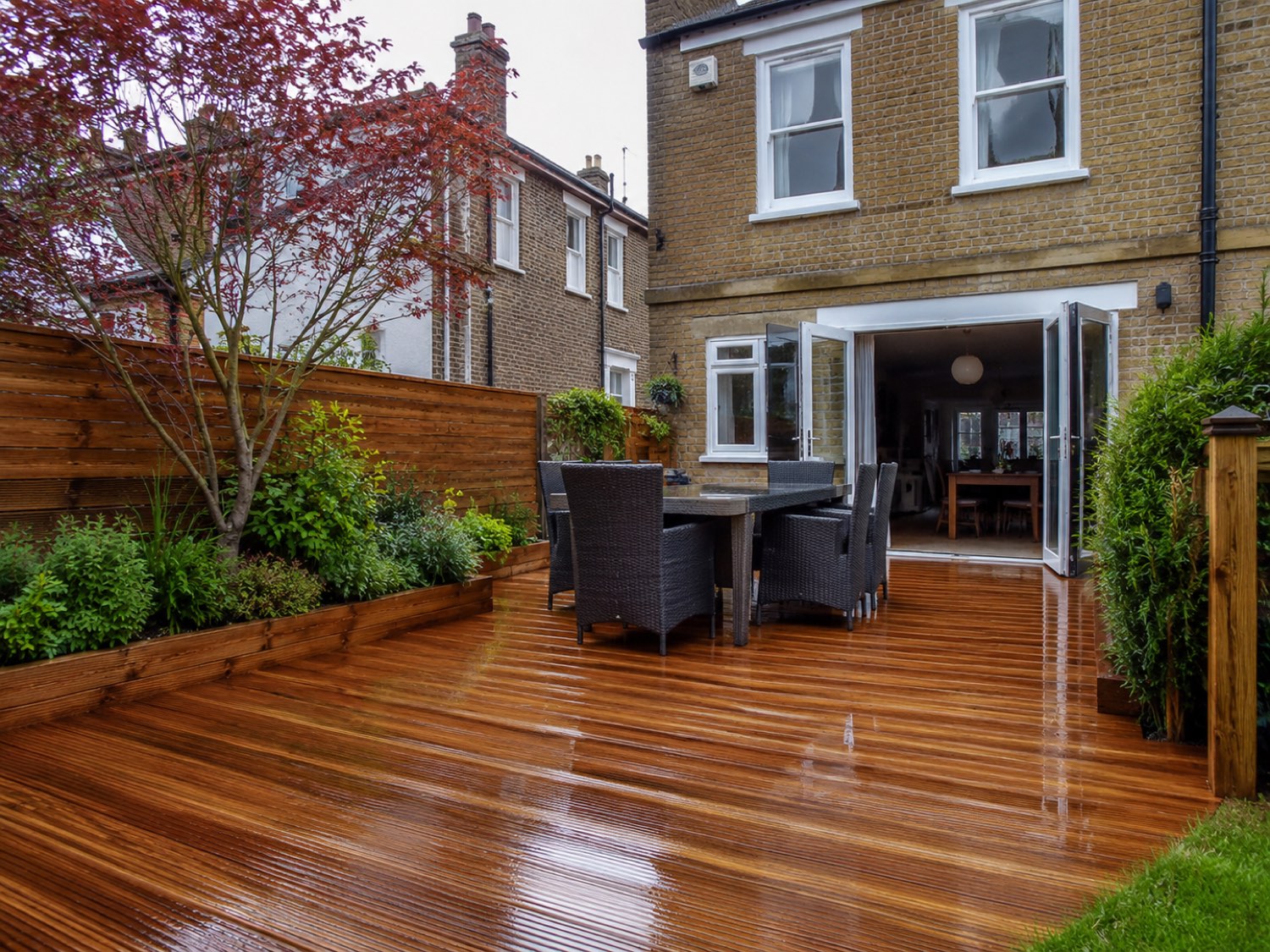 The same decking after cleaning and oiling — colour restored